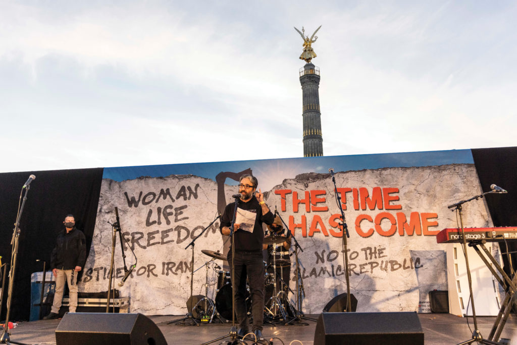 Hamed speaks at podium in Berlin